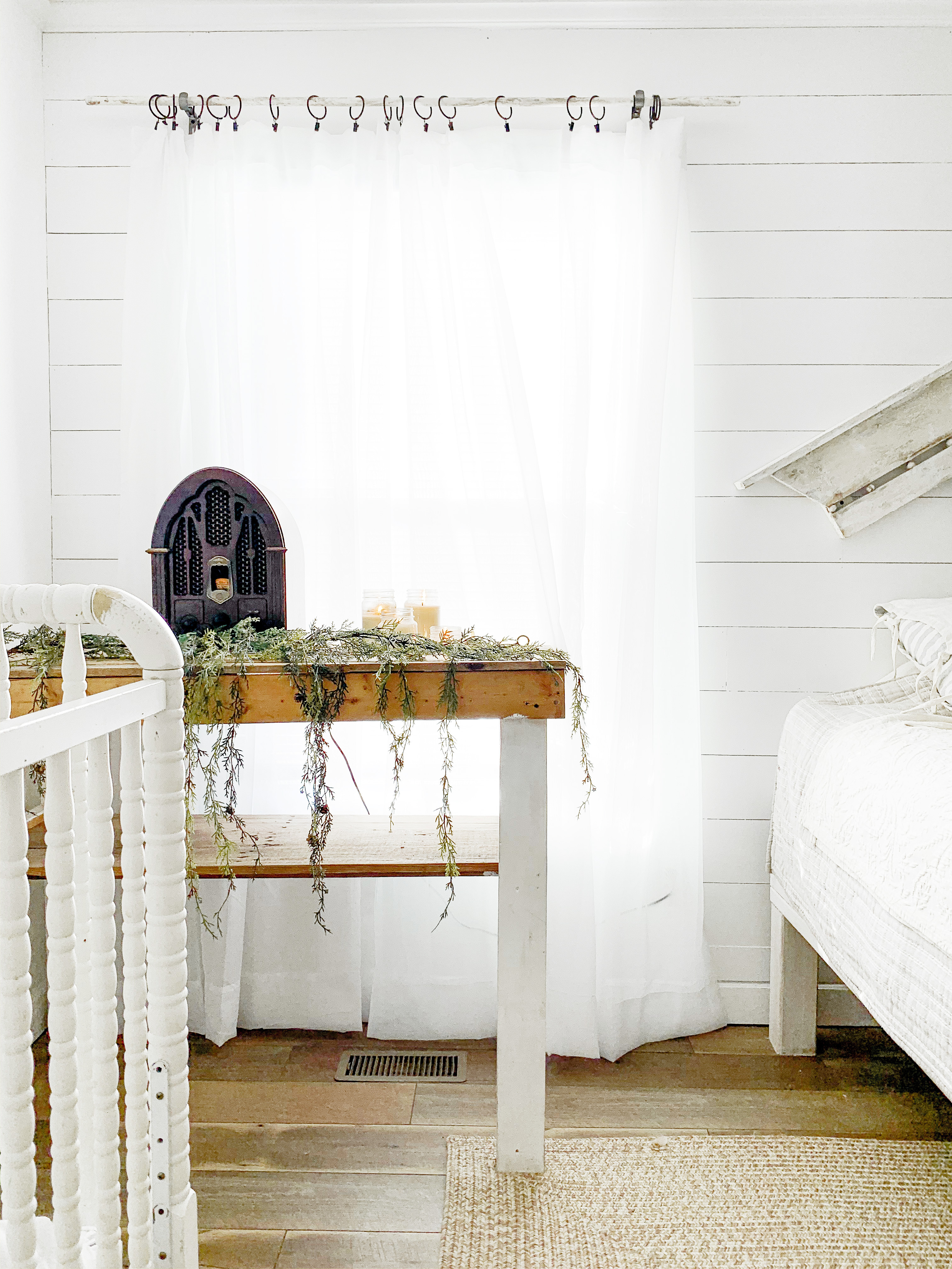 Cozy Cottage Style Farmhouse Bedroom Decorated For Christmas With Layered Wreaths & Twinkle Lights